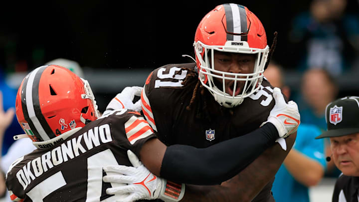 Cleveland Browns defensive end Alex Wright (91) celebrates his sack on Jacksonville Jaguars quarterback Trevor Lawrence (16) in the end zone for a safety with defensive end Ogbo Okoronkwo (54) during the fourth quarter of an NFL football matchup Sunday, Sept. 15, 2024 at EverBank Stadium in Jacksonville, Fla. The Browns defeated the Jaguars 18-13. [Corey Perrine/Florida Times-Union]