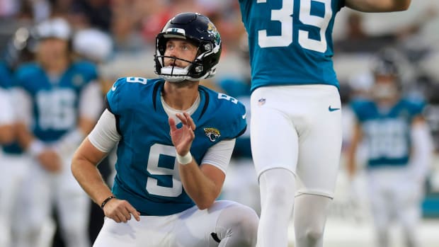 Jacksonville Jaguars place kicker Cam Little kicks his first field goal as punter Logan Cooke who held, looks on.