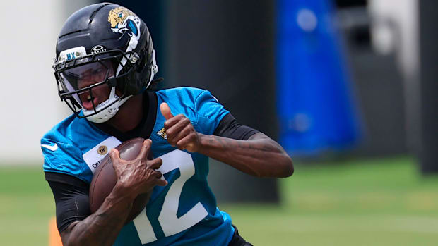 Jacksonville Jaguars wide receiver Travis Hunter (12) runs the ball during a rookie minicamp at Miller Electric Center Saturd