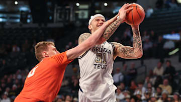 Jan 14, 2025; Atlanta, Georgia, USA; Clemson Tigers center Viktor Lakhin (0) fouls against Georgia Tech Yellow Jackets forward Duncan Powell (31) during the first half at McCamish Pavilion. Mandatory Credit: Jordan Godfree-Imagn Images