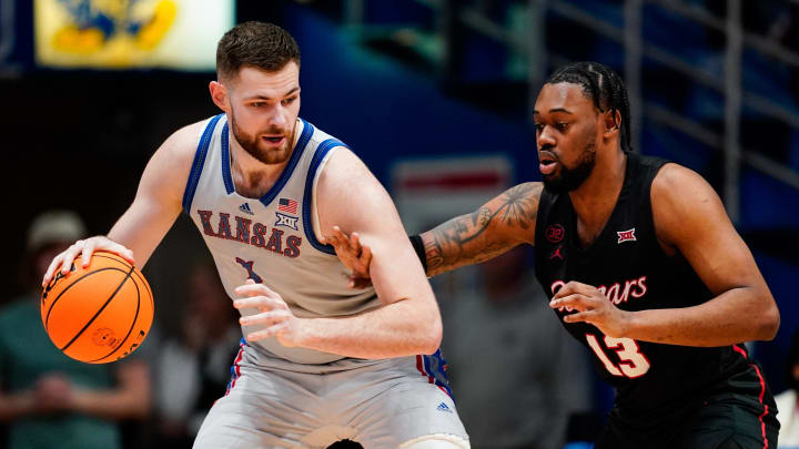 Feb 3, 2024; Lawrence, Kansas, USA; Kansas Jayhawks center Hunter Dickinson (1) dribbles the ball against Houston Cougars forward J'Wan Roberts (13) during the first half at Allen Fieldhouse. Mandatory Credit: Jay Biggerstaff-USA TODAY Sports