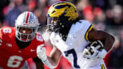 Michigan running back Donovan Edwards (7) runs against Ohio State during the first half at Ohio Stadium in Columbus, Ohio on Saturday, Nov. 30, 2024.