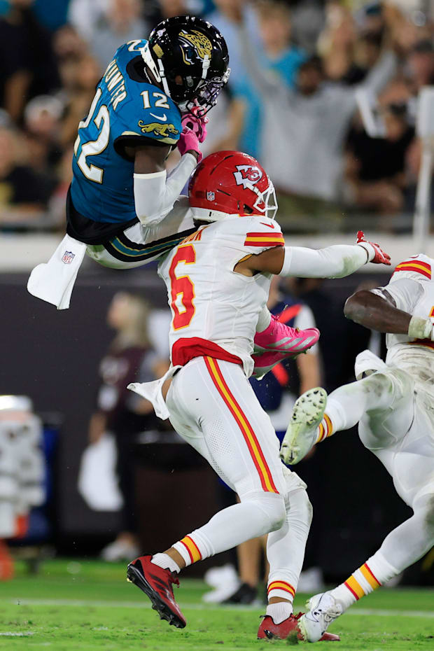 Jacksonville Jaguars wide receiver Travis Hunter (12) hauls in a reception against Kansas City Chiefs safety Bryan Cook (6) d