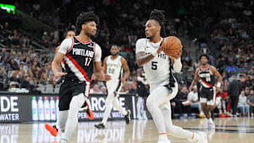 Nov 7, 2024; San Antonio, Texas, USA;  San Antonio Spurs guard Stephon Castle (5) drives against Portland Trail Blazers guard Shaedon Sharpe (17) in the first half at Frost Bank Center. 