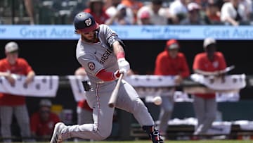 May 18, 2025; Baltimore, Maryland, USA; Washington Nationals center fielder Dylan Crews (3) hits an infield single against the Baltimore Orioles during the fourth inning at Oriole Park at Camden Yards. 