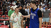 Actor Jason Sudeikis speaks with Dallas Mavericks forward Cooper Flagg after the Mavericks played the San Antonio Spurs