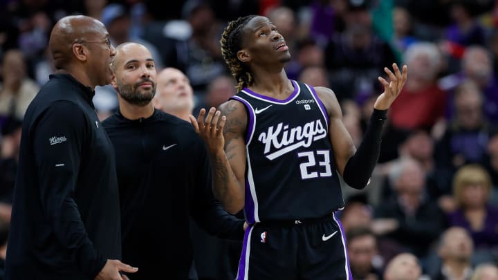 Mar 25, 2024; Sacramento, California, USA; Sacramento Kings guard Keon Ellis (23) reviews a call with head coach Mike Brown during the second quarter against the Philadelphia 76ers at Golden 1 Center. Mandatory Credit: Sergio Estrada-USA TODAY Sports