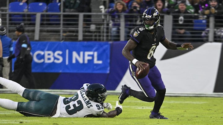 Dec 1, 2024; Baltimore, Maryland, USA; Baltimore Ravens quarterback Lamar Jackson (8) scrambles away from Philadelphia Eagles defensive tackle Milton Williams (93) during the first quarter  at M&T Bank Stadium. Mandatory Credit: Tommy Gilligan-Imagn Images