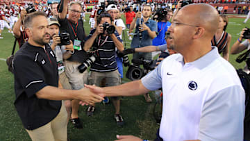 Former Temple and current Nebraska head coach Matt Rhule (left) shakes hands with Penn State head coach James Franklin (right)