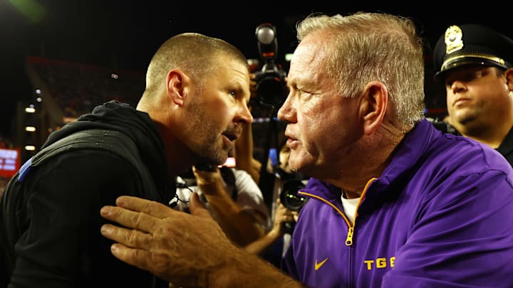 Nov 16, 2024; Gainesville, Florida, USA; LSU Tigers head coach Brian Kelly and Florida Gators head coach Billy Napier greet after the game at Ben Hill Griffin Stadium. Mandatory Credit: Kim Klement Neitzel-Imagn Images