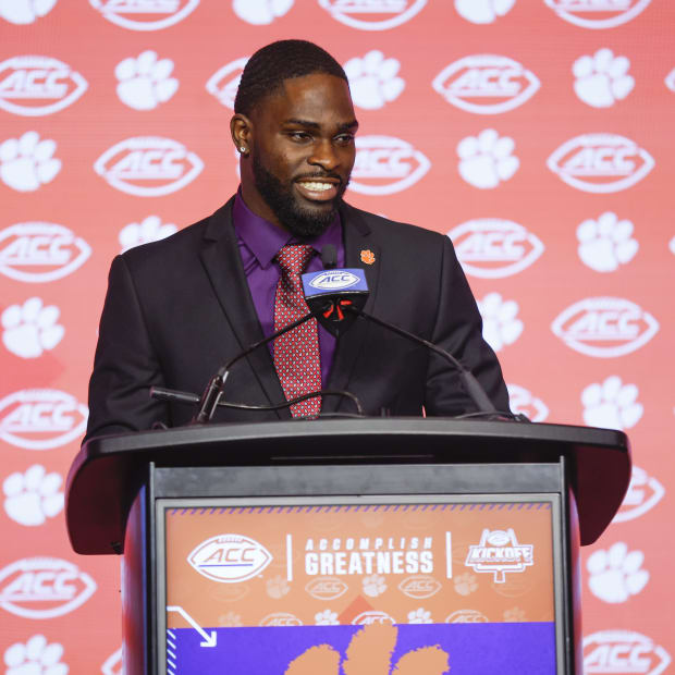 Phil Mafah stands behind the podium at the ACC Kickoff, ready to answer questions.