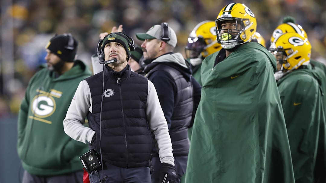 Jan 22, 2022; Green Bay, Wisconsin, USA; Green Bay Packers head coach Matt LaFleur (center) looks on from the sidelines in the first half against the San Francisco 49ers during a NFC Divisional playoff football game at Lambeau Field. Mandatory Credit: Jeff Hanisch-Imagn Images