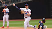 Jul 2, 2025; New York City, New York, USA;  New York Mets second baseman Brett Baty (7) forces out Milwaukee Brewers outfielder Jake Bauers (9) at second base and throws to first to complete the double play on a ball hit by shortstop Joey Ortiz (not pictured) during the fourth inning at Citi Field. Mandatory Credit: Vincent Carchietta-Imagn Images