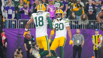 Dec 29, 2024; Minneapolis, Minnesota, USA; Green Bay Packers wide receiver Malik Heath (18) celebrates his touchdown with wide receiver Bo Melton (80) against Minnesota Vikings in the fourth quarter at U.S. Bank Stadium. Mandatory Credit: Brad Rempel-Imagn Images