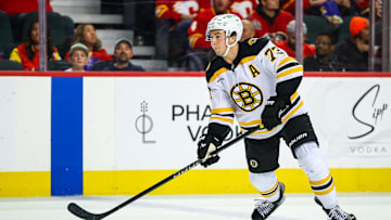 Dec 17, 2024; Calgary, Alberta, CAN; Boston Bruins defenseman Charlie McAvoy (73) controls the puck against the Calgary Flames during the third period at Scotiabank Saddledome. Mandatory Credit: Sergei Belski-Imagn Images