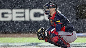 Aug 2, 2025; Bristol, Tennessee, USA; Atlanta Braves catcher Sean Murphy (12) prepares to defend the plate as rain falls during the first inning of the Speedway Classic game against the Cincinnati Reds at Bristol Motor Speedway. Mandatory Credit: Randy Sartin-Imagn Images
