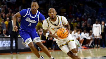 vMar 20, 2025; Wichita, KS, USA; Missouri Tigers guard Tamar Bates (2) drives against Drake Bulldogs forward Cam Manyawu (3) in the first half of a first round men’s NCAA Tournament game at Intrust Bank Arena. Mandatory Credit: Nick Tre. Smith-Imagn Images