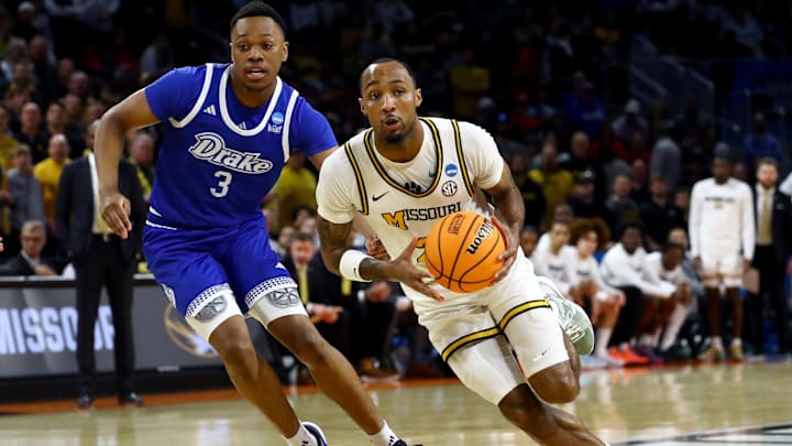 vMar 20, 2025; Wichita, KS, USA; Missouri Tigers guard Tamar Bates (2) drives against Drake Bulldogs forward Cam Manyawu (3) in the first half of a first round men’s NCAA Tournament game at Intrust Bank Arena. Mandatory Credit: Nick Tre. Smith-Imagn Images