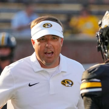 Aug 29, 2024; Columbia, Missouri, USA; Missouri Tigers head coach Eli Drinkwitz greets Missouri Tigers running back Nate Noel (8) during stretching against the Murray State Racers prior to a game at Faurot Field at Memorial Stadium. Mandatory Credit: Denny Medley-USA TODAY Sports