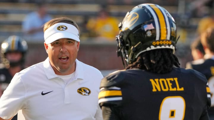 Aug 29, 2024; Columbia, Missouri, USA; Missouri Tigers head coach Eli Drinkwitz greets Missouri Tigers running back Nate Noel (8) during stretching against the Murray State Racers prior to a game at Faurot Field at Memorial Stadium. Mandatory Credit: Denny Medley-USA TODAY Sports