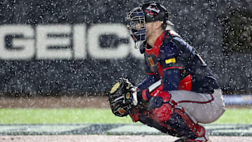 Atlanta Braves catcher Sean Murphy (12) prepares to defend the plate as rain falls during the first inning of the Speedway Classic game against the Cincinnati Reds at Bristol Motor Speedway.