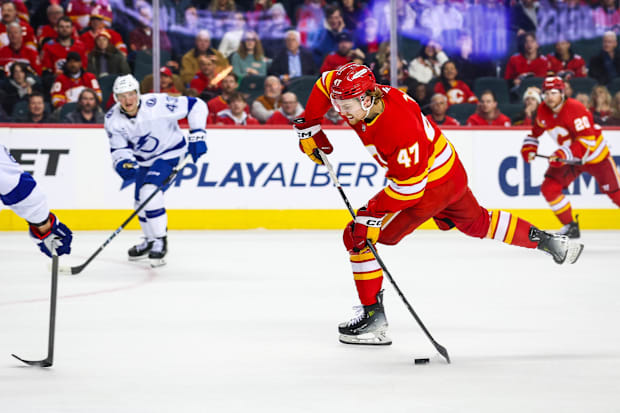 Hockey player in red uniform shoots the puck