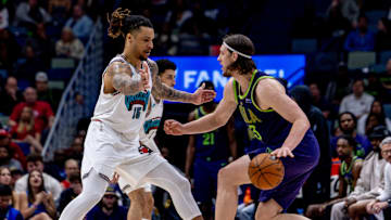 Mar 9, 2025; New Orleans, Louisiana, USA;  New Orleans Pelicans forward Kelly Olynyk (13) dribbles against Memphis Grizzlies forward Brandon Clarke (15) during the second half at Smoothie King Center. Mandatory Credit: Stephen Lew-Imagn Images