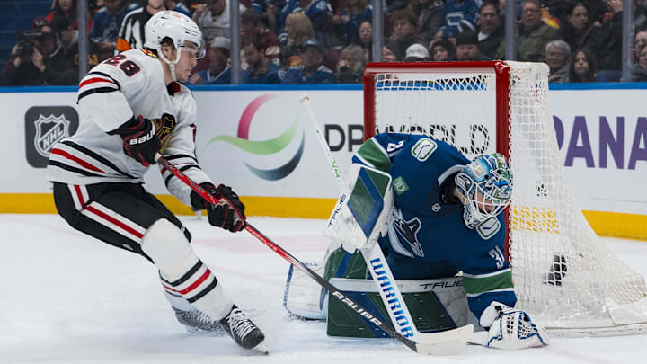 Mar 15, 2025; Vancouver, British Columbia, CAN; Vancouver Canucks goalie Arturs Silovs (31) makes a save on Chicago Blackhawks forward Colton Dach (28) in the second period at Rogers Arena.