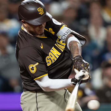 Sep 10, 2024; Seattle, Washington, USA;  San Diego Padres third baseman Manny Machado (13) hits a two-run single during the seventh inning against the Seattle Mariners at T-Mobile Park. Mandatory Credit: Stephen Brashear-Imagn Images