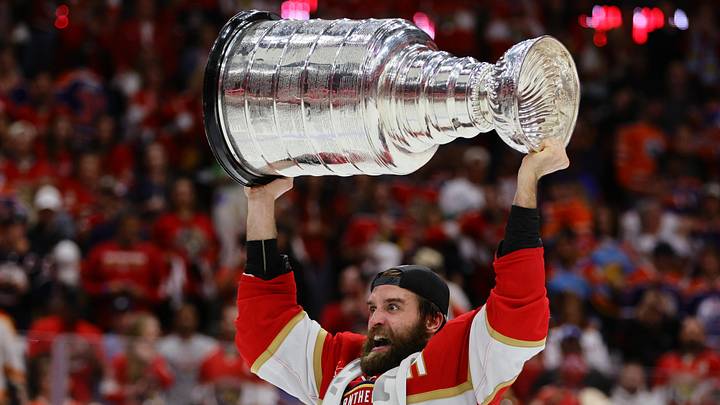 Jun 24, 2024; Sunrise, Florida, USA; Florida Panthers defenseman Aaron Ekblad (5) hoists the Stanley Cup after defeating the Edmonton Oilers in game seven of the 2024 Stanley Cup Final at Amerant Bank Arena. Mandatory Credit: Sam Navarro-Imagn Images
