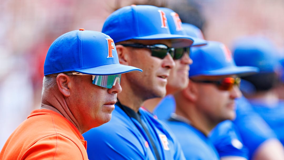 Florida Head Coach Kevin O'Sullivan (orange shirt) stands with players and other assistants prior to the start of a Gator game this season.