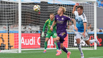 Jun 19, 2024; Charlotte, North Carolina, USA; Orlando City midfielder Dagur Thorhallsson (17) and Charlotte FC midfielder Andrew Privett (34) chase the ball during the first half at Bank of America Stadium. Mandatory Credit: Jim Dedmon-USA TODAY Sports