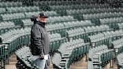 Denver, CO, USA; A Colorado Rockies fans stands as snow falls before a game against the Atlanta Braves at Coors Field.