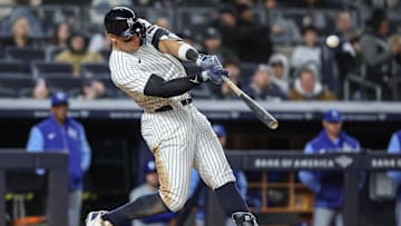 Apr 16, 2025; Bronx, New York, USA;  New York Yankees designated hitter Aaron Judge (99) hits a solo home run in the seventh inning against the Kansas City Royals at Yankee Stadium. 
