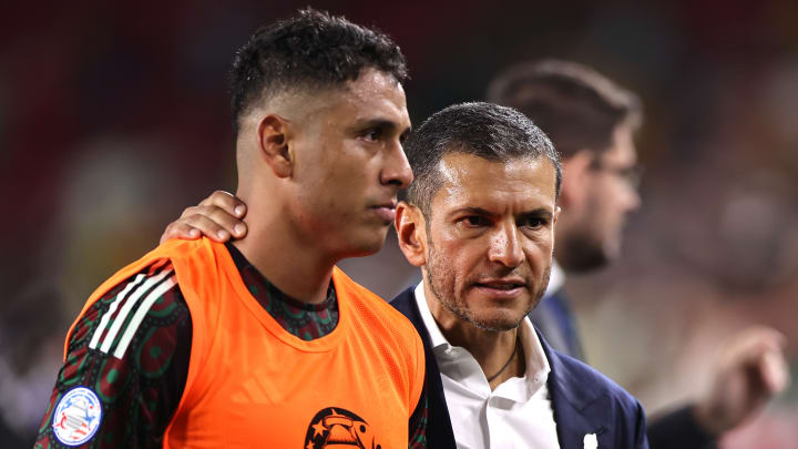 Mexico coach Jaime Lozano (right) walks off the field with Luis Romo after El Tri was eliminated from the Copa América on Sunday night. 