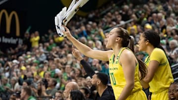 Oregon guard Peyton Scott cheers on a basket by Oregon guard Nani Falatea as the Oregon Ducks host the Auburn Tigers on Wednesday, Nov. 20, 2024, at Matthew Knight Arena in Eugene, Ore.