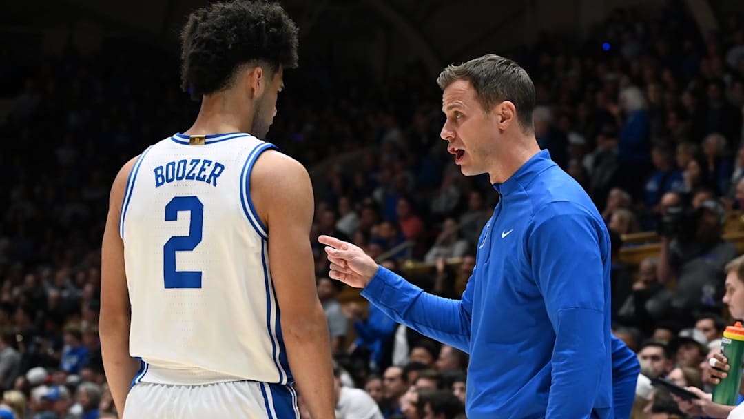 Nov 14, 2025; Durham, North Carolina, USA; Duke Blue Devils guard Cayden Boozer (2) takes direction from head coach Jon Scheyer during the first half against the Indiana State Sycamores at Cameron Indoor Stadium. Mandatory Credit: Rob Kinnan-Imagn Images
