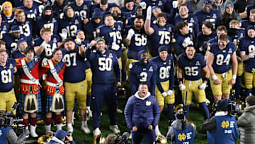 Dec 20, 2024; Notre Dame, Indiana, USA; Notre Dame Fighting Irish head coach Marcus Freeman celebrates with his team after defeating the Indiana Hoosiers in the first round of the College Football Playoff at Notre Dame Stadium. Mandatory Credit: Matt Cashore-Imagn Images