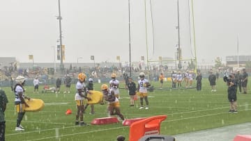 Packers running backs are bringing the intensity during drills amid heavy rain at Ray Nitschke Field.