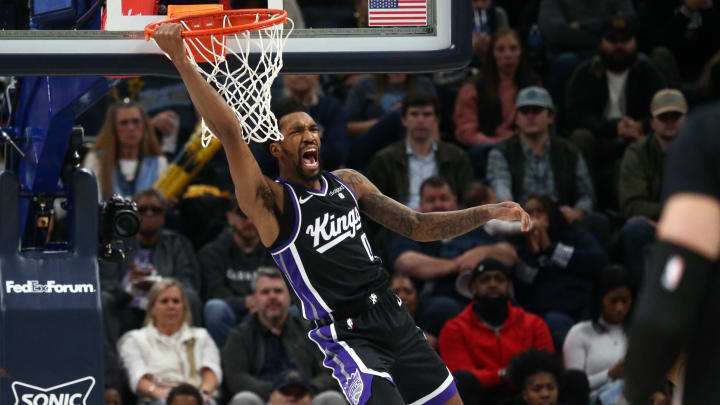 Dec 31, 2023; Memphis, Tennessee, USA; Sacramento Kings guard Malik Monk (0) reacts as he hangs from the rim after a dunk during the second half against the Memphis Grizzlies at FedExForum. Mandatory Credit: Petre Thomas-USA TODAY Sports