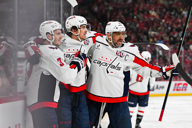 Hockey players celebrate a goal score