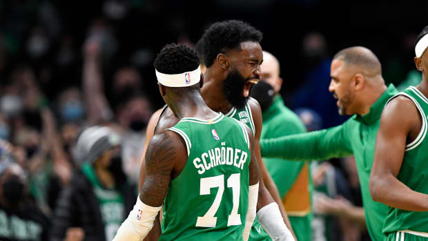 Jan 2, 2022; Boston, Massachusetts, USA; Boston Celtics guard Jaylen Brown (7) reacts with guard Dennis Schroder (71) during a timeout in overtime at the TD Garden. Mandatory Credit: Brian Fluharty-USA TODAY Sports