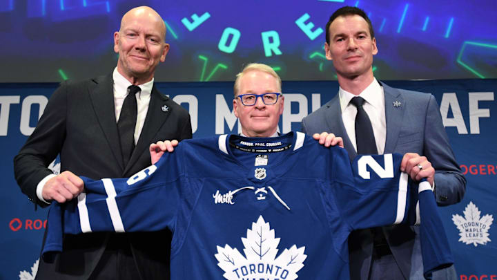 May 4, 2026; Toronto, Ontario, CANADA;  Maple Leaf Sports and Entertainment CEO Keith Pelley holds a team jersey between Toronto Maple Leafs general manager John Chayka (right) and senior executive advisor Mats Sundin during an introductory news conference at Real Sports Bar and Grill. Mandatory Credit: Dan Hamilton-Imagn Images