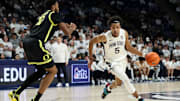 Penn State Nittany Lions forward Puff Johnson dribbles the ball toward the basket as Oregon Ducks forward Kwame Evans Jr. defends during the first half at Bryce Jordan Center. 