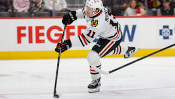 Nov 9, 2025; Detroit, Michigan, USA; Chicago Blackhawks center Oliver Moore (11) takes a shot on Detroit Red Wings goaltender John Gibson (36) (not pictured) during the first period at Little Caesars Arena. Mandatory Credit: Brian Bradshaw Sevald-Imagn Images