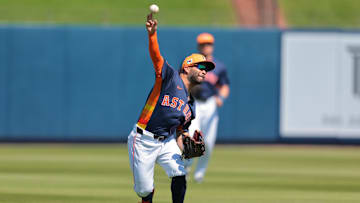 Mar 2, 2025; West Palm Beach, Florida, USA; Houston Astros left fielder Jose Altuve (27) throws to home plate but cannot retire Washington Nationals first baseman Nathaniel Lowe (not pictured) during the first inning at CACTI Park of the Palm Beaches. 
