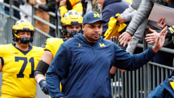 Michigan offensive line coach Grant Newsome talks to Blue Team players during the second half of the spring game at Michigan Stadium in Ann Arbor on Saturday, April 20, 2024.