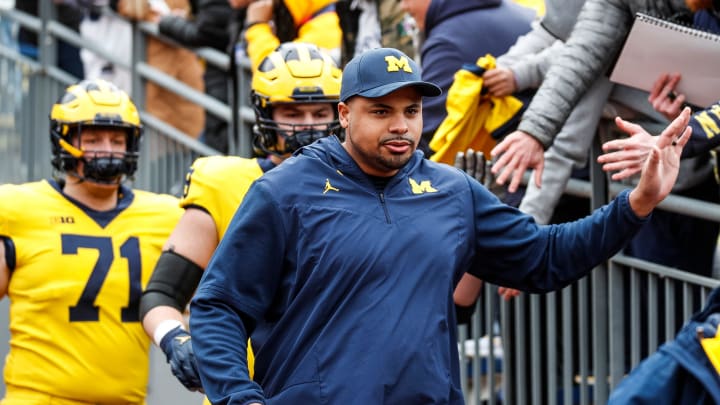 Michigan offensive line coach Grant Newsome talks to Blue Team players during the second half of the spring game at Michigan Stadium in Ann Arbor on Saturday, April 20, 2024.