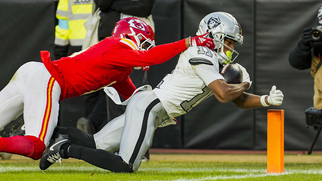 Nov 29, 2024; Kansas City, Missouri, USA; Las Vegas Raiders wide receiver Tre Tucker (11) scores a touchdown against Las Vegas Raiders place kicker Daniel Carlson (2) during the second half at GEHA Field at Arrowhead Stadium. Mandatory Credit: Jay Biggerstaff-Imagn Images