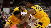 Cal's Spencer Mahoney (left) and Christian Tucker tie up Stanford Cardinal's Jaylen Blakes